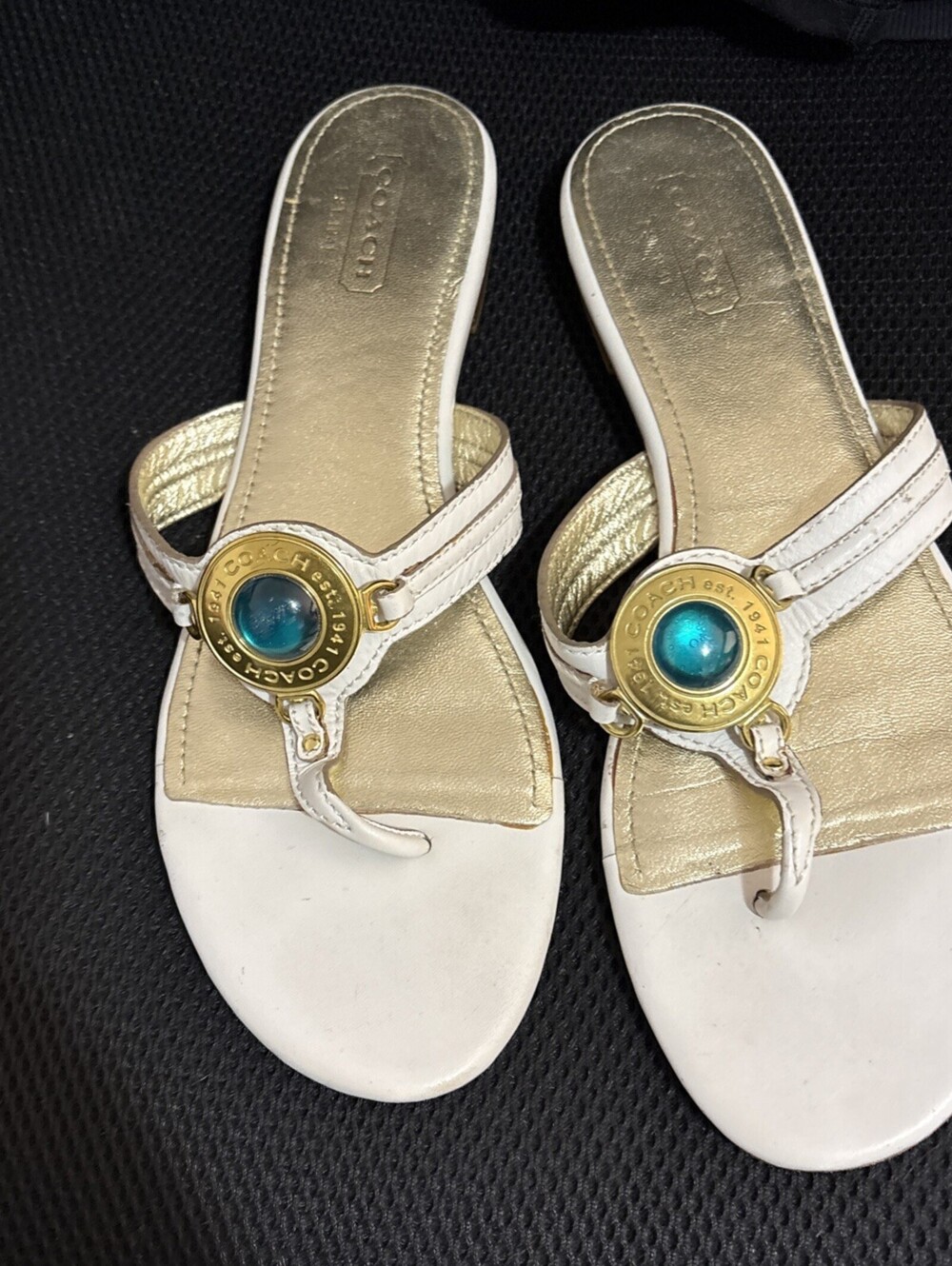 Coach gold leather thong sandals featuring a distinct teal medallion accent Sz9